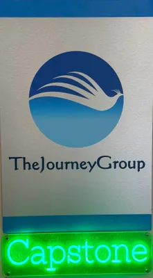 The neon Capstone highlights the course at a top tier business college where students learn by actual engagement with companies to improve the companys performance This sign hangs in the office of the Capstone Director to remind all visitors of the unique course